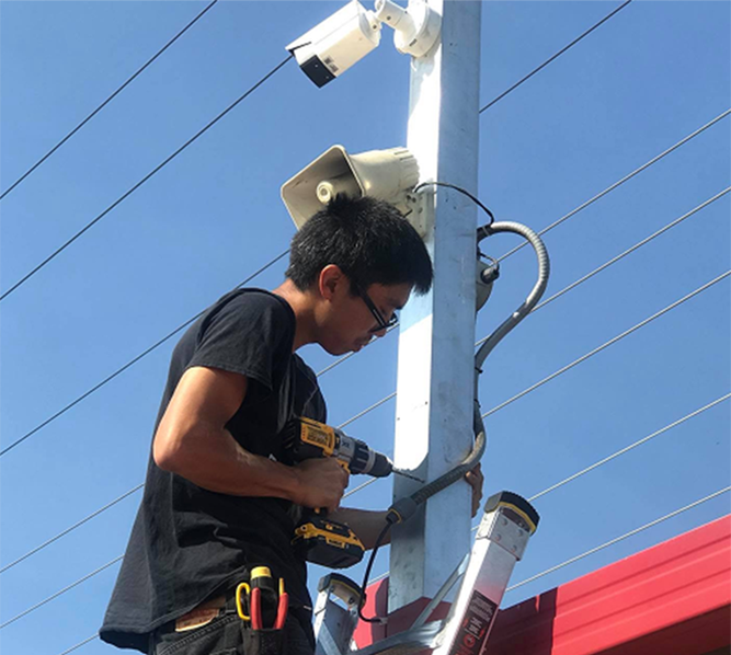 See Clear technician installing security camera